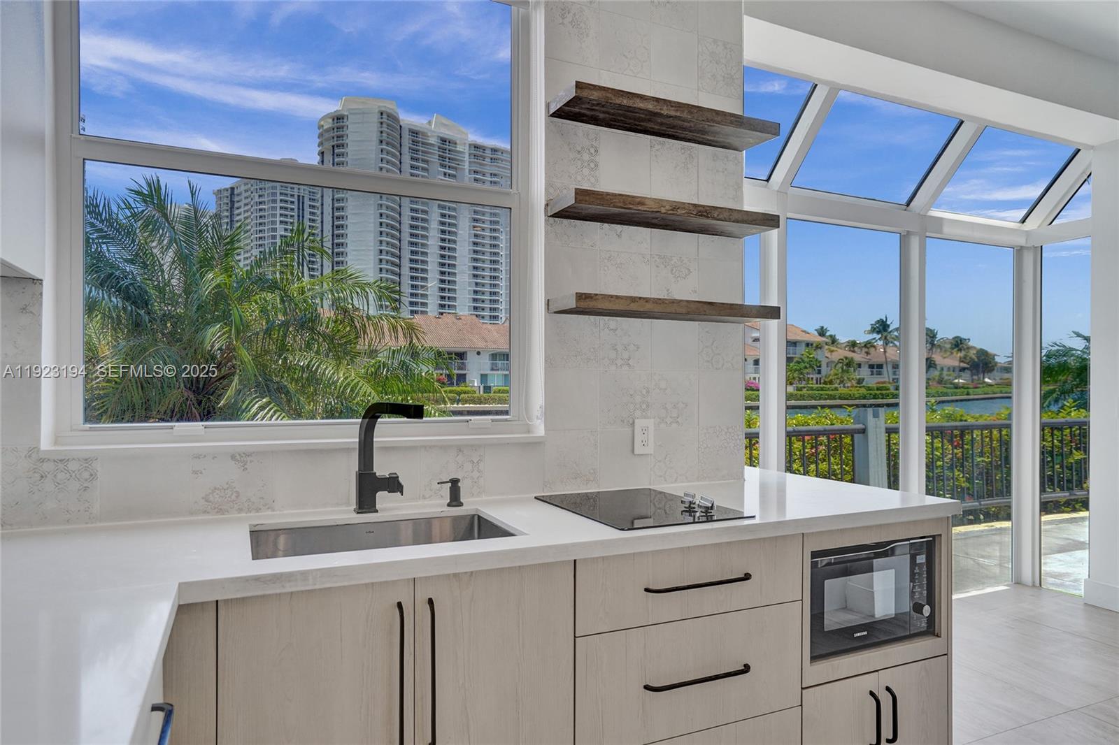 3757 Northeast 208th Terrace Aventura, FL 33180 - Photo 17 of 74 a kitchen with a sink and large window
