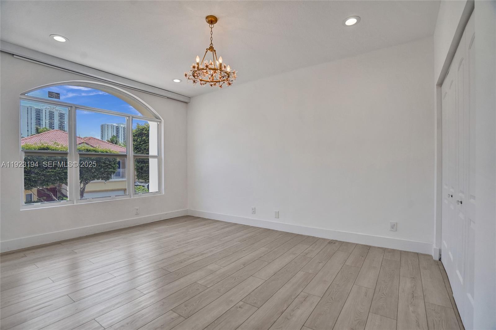 3757 Northeast 208th Terrace Aventura, FL 33180 - Photo 39 of 74 an empty room with wooden floor and windows