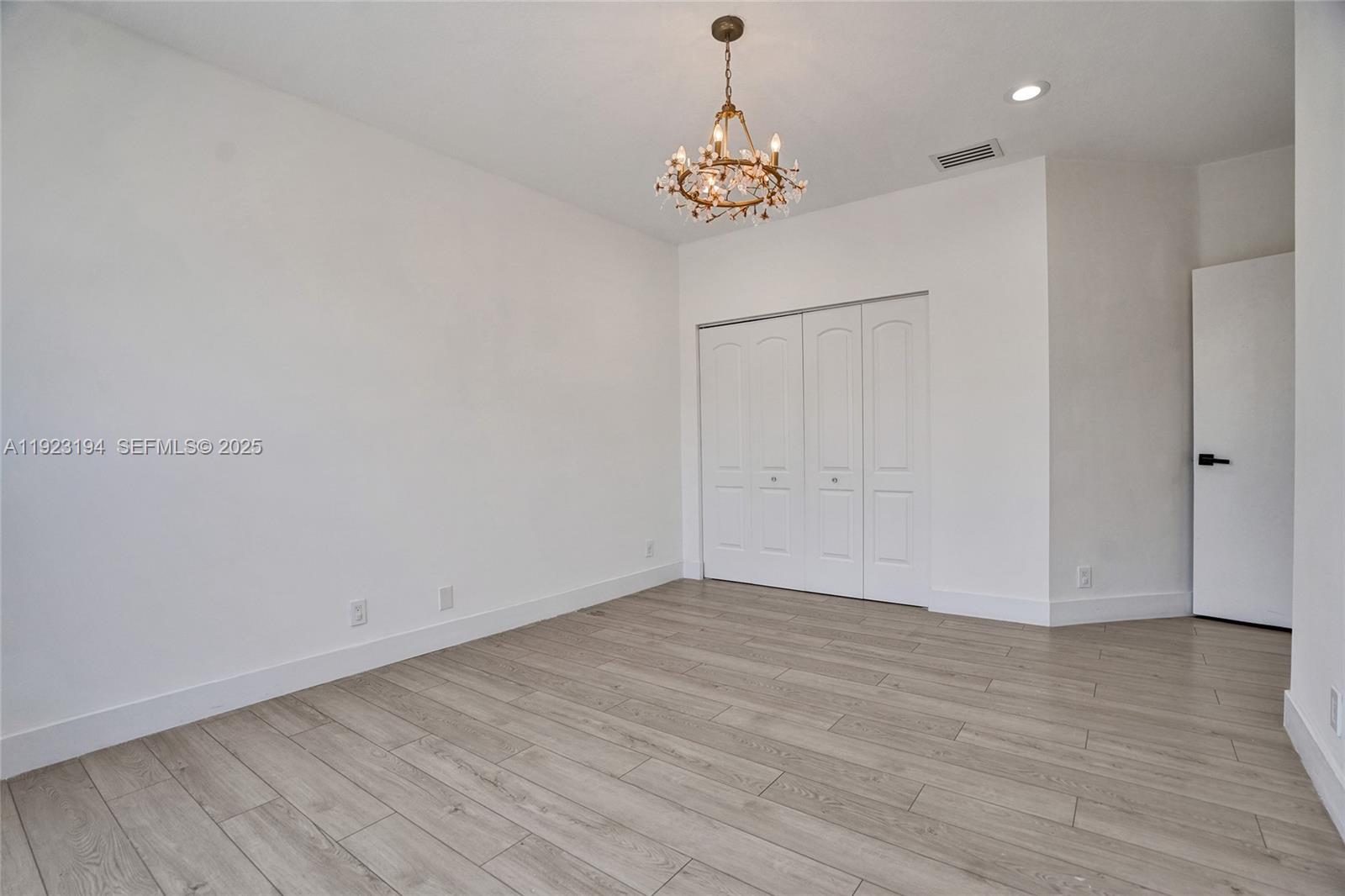 3757 Northeast 208th Terrace Aventura, FL 33180 - Photo 40 of 74 a view of an empty room with wooden floor