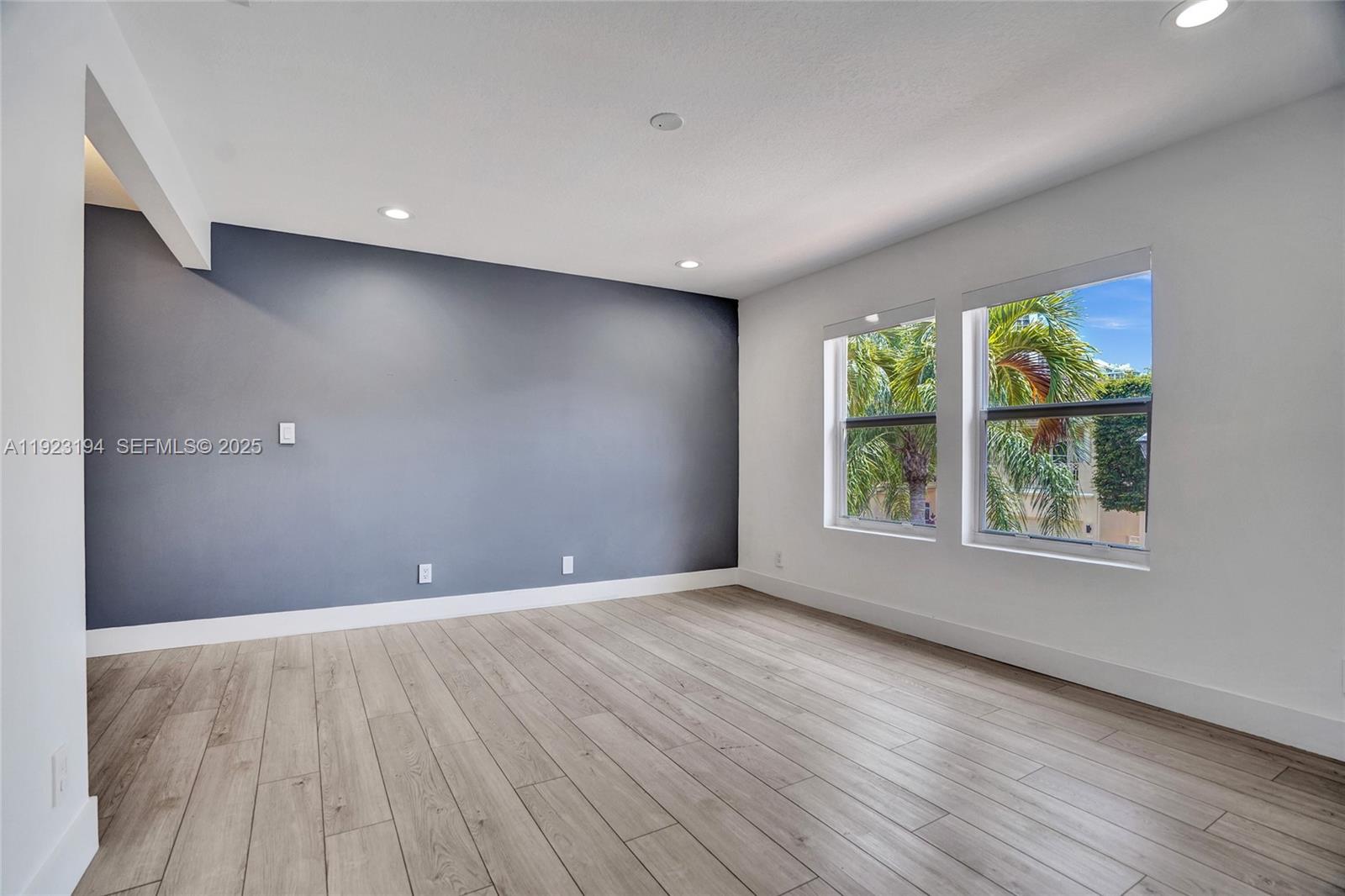 3757 Northeast 208th Terrace Aventura, FL 33180 - Photo 43 of 74 an empty room with wooden floor and windows