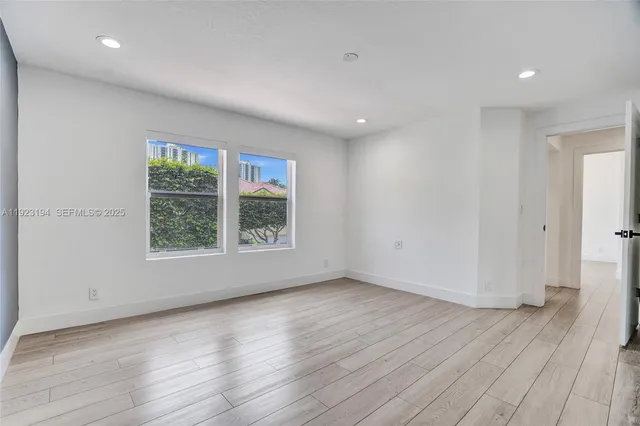 a view of a lake with a patio table and chairs