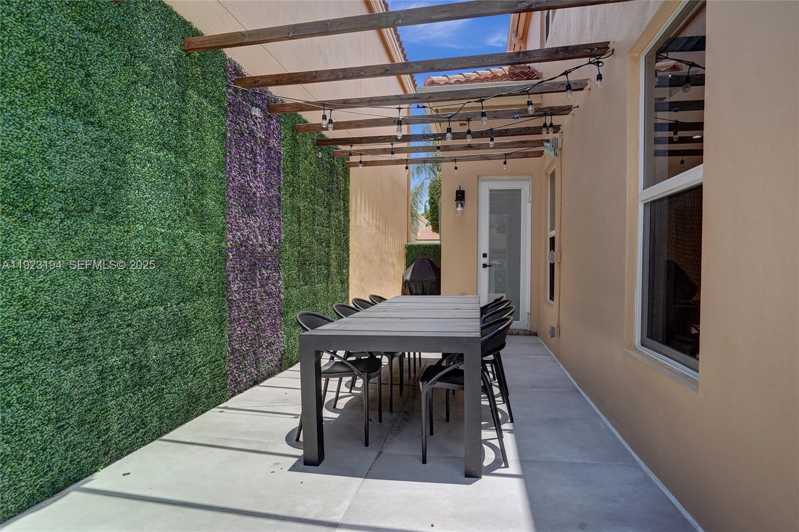 3757 Northeast 208th Terrace Aventura, FL 33180 - Photo 50 of 74 a view of a dinning table and chairs in the porch