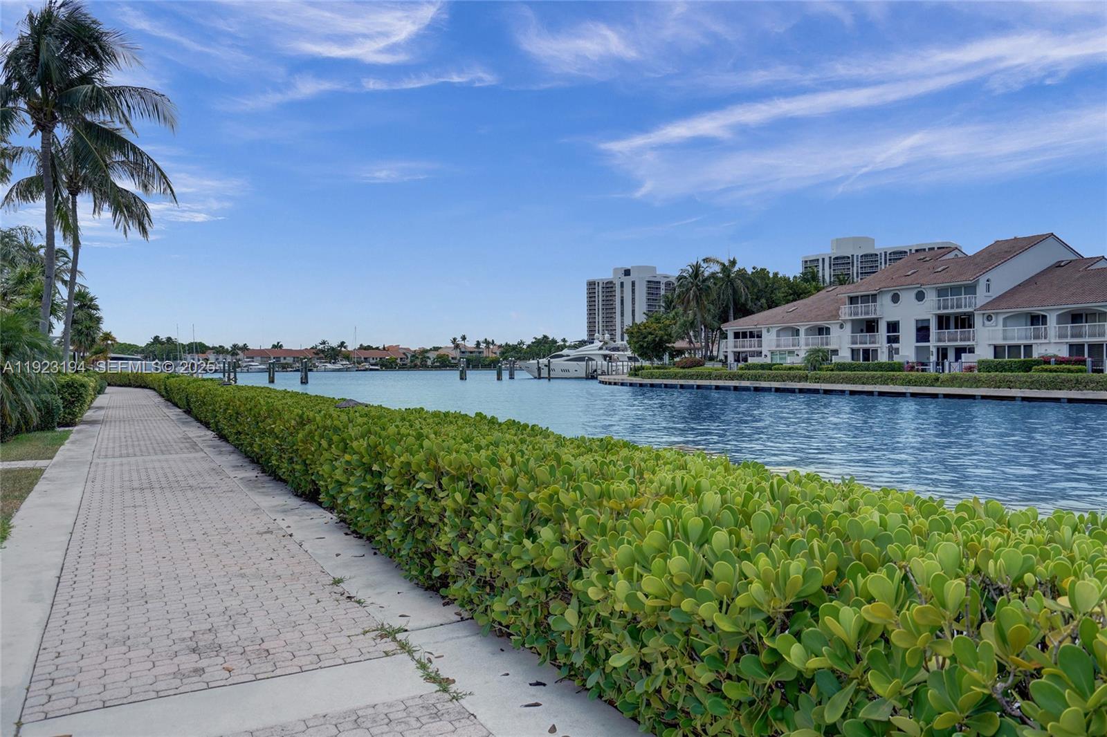 3757 Northeast 208th Terrace Aventura, FL 33180 - Photo 54 of 74 a view of a lake with houses in the back