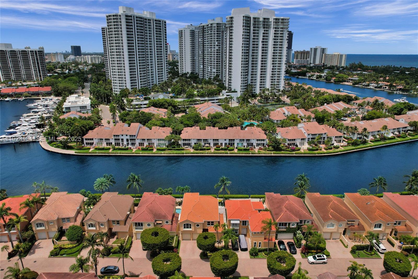 3757 Northeast 208th Terrace Aventura, FL 33180 - Photo 63 of 74 a view of a lake with a patio table and chairs