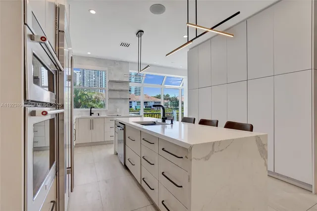 a kitchen with a sink and a refrigerator