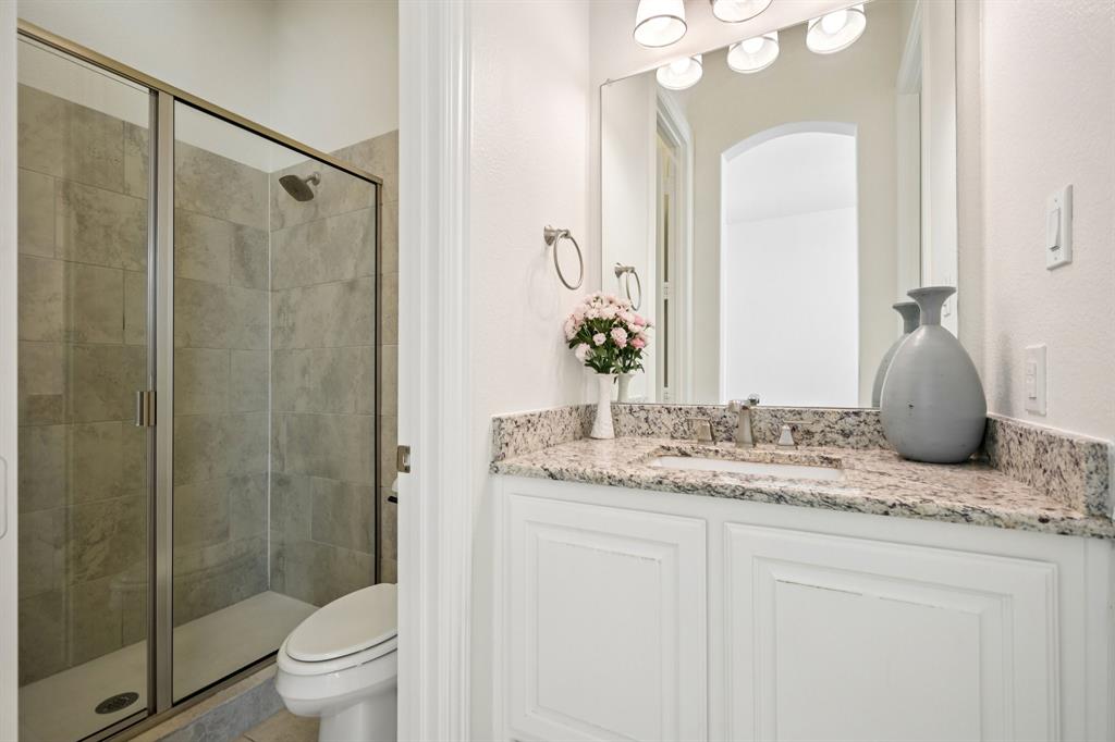 2029 Temperate Drive Allen, TX 75013 - Photo 18 of 40 a bathroom with a granite countertop sink toilet and shower