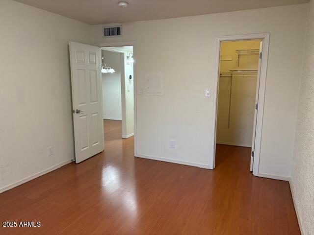 2121 West Royal Palm Road, Unit 2074 Phoenix, AZ 85021 - Photo 14 of 22 an empty room with wooden floor and closet