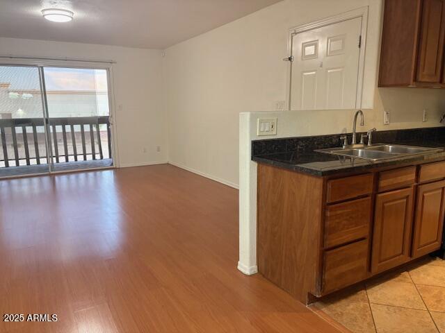 2121 West Royal Palm Road, Unit 2074 Phoenix, AZ 85021 - Photo 2 of 22 a kitchen with granite countertop a sink cabinets and wooden floor