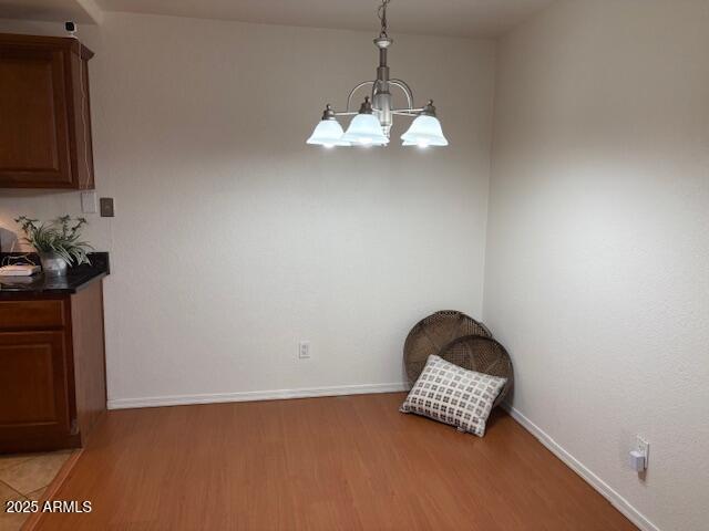 2121 West Royal Palm Road, Unit 2074 Phoenix, AZ 85021 - Photo 5 of 22 a view of a chandelier fan and wooden floor