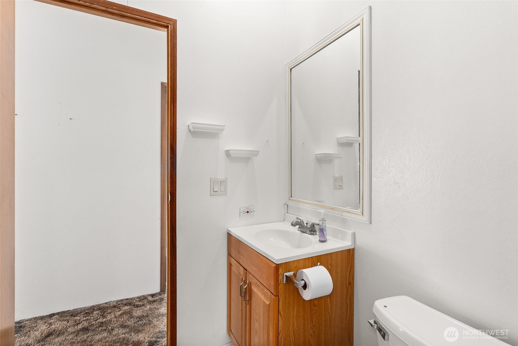 104 Sun Valley Drive Chehalis, WA 98532 - Photo 17 of 29 a bathroom with a sink a toilet and a mirror