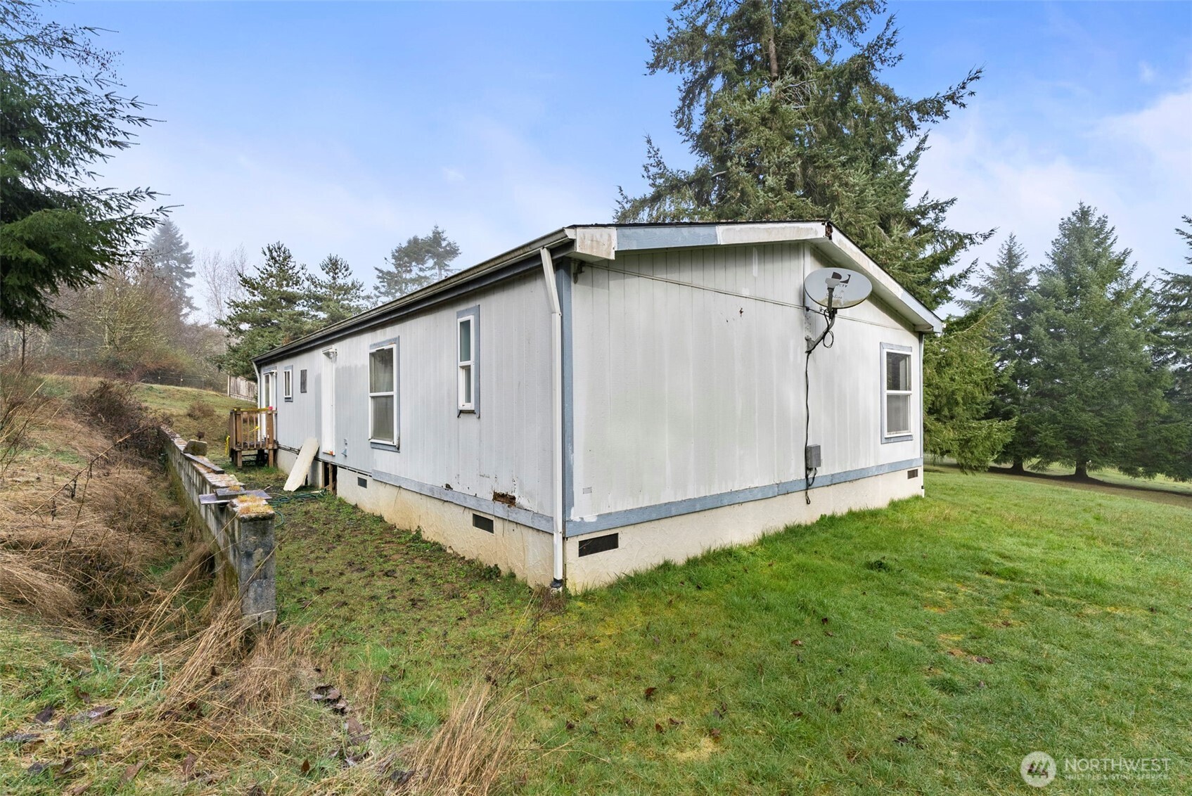 104 Sun Valley Drive Chehalis, WA 98532 - Photo 23 of 29 a white house with a small yard and trees