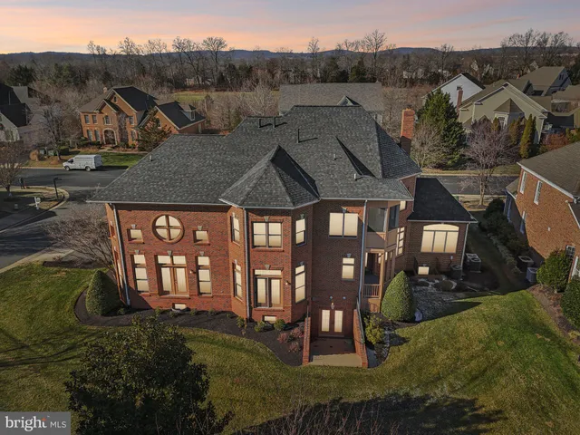 a aerial view of a house with swimming pool and a yard