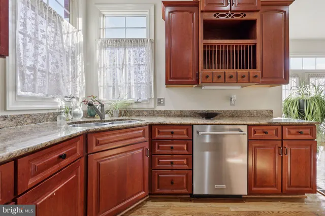 a view of staircase with railing and white walls