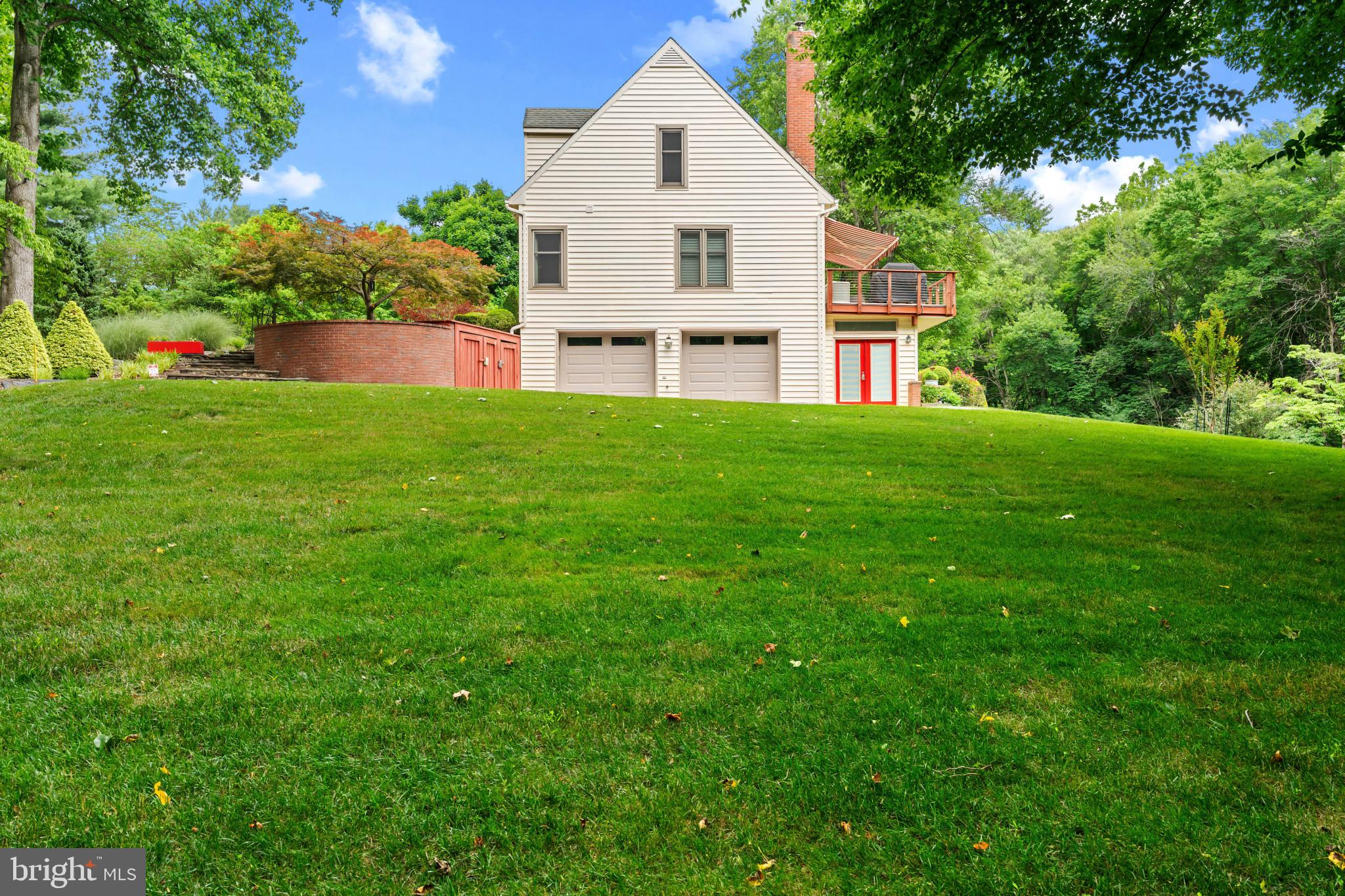10821 Braeburn Road Columbia, MD 21044 - Photo 7 of 64 a view of a house with a big yard and large trees