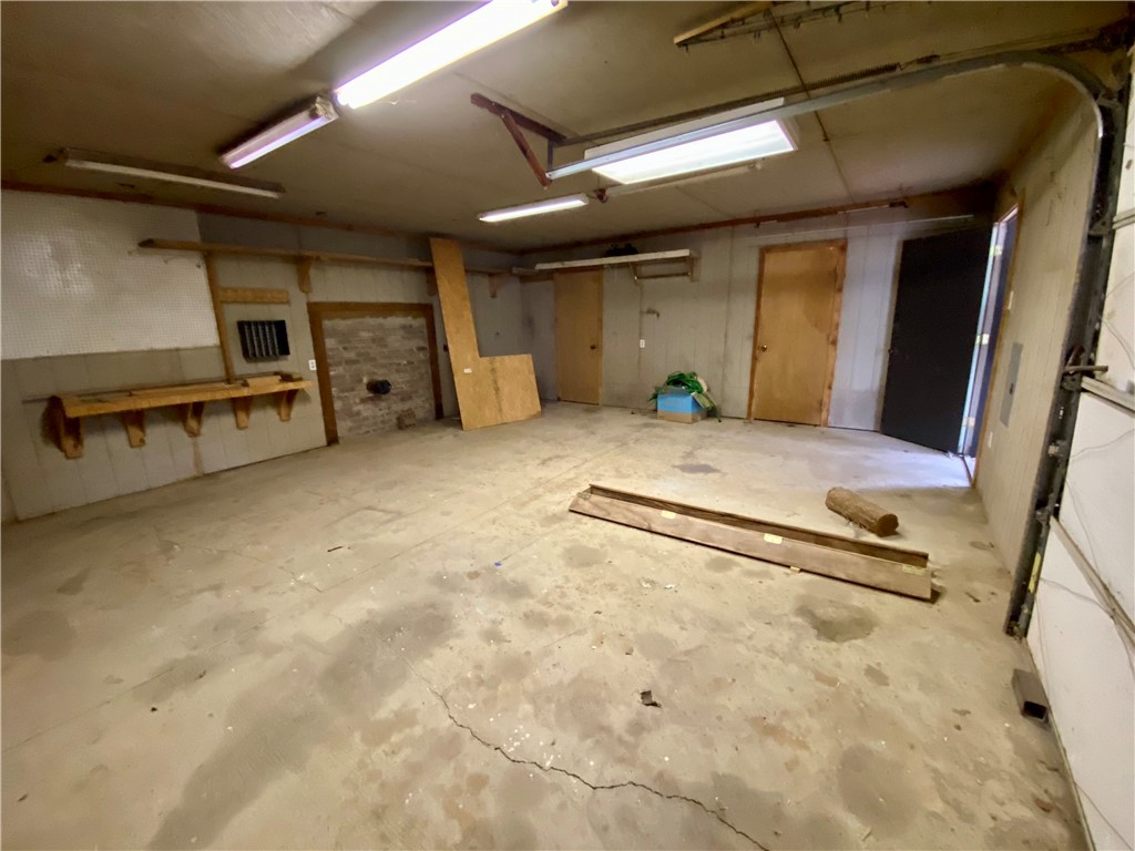 648 Dequeen Lake Road De Queen, AR 71832 - Photo 43 of 46 This spacious garage features a concrete floor, fluorescent lighting, and a workbench
