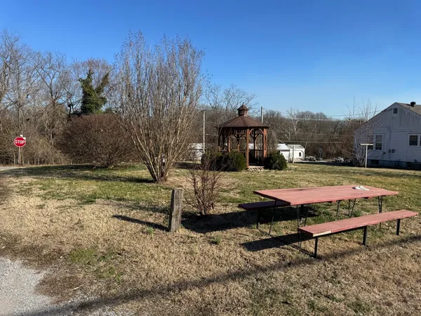 a view of a yard with table and chairs