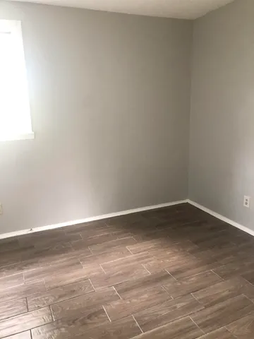 a view of an empty room and wooden floor