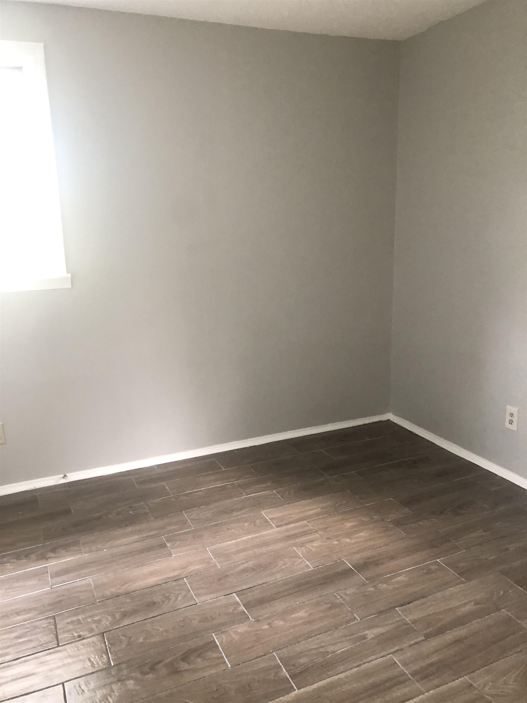 1698 Rayner Street Memphis, TN 38106 - Photo 8 of 8 a view of an empty room and wooden floor
