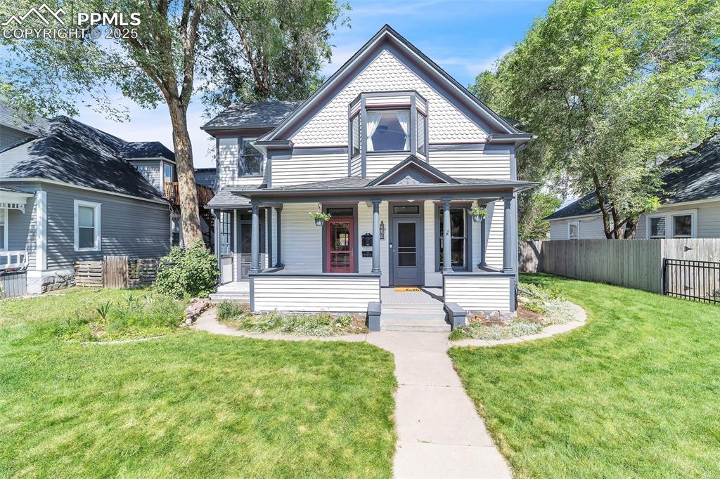 a front view of a house with a yard table and chairs