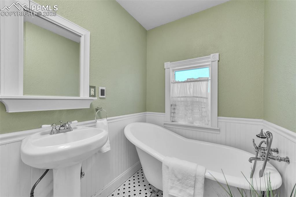 319 South Institute Street Colorado Springs, CO 80903 - Photo 15 of 49 a bathroom with a bathtub a sink and a window