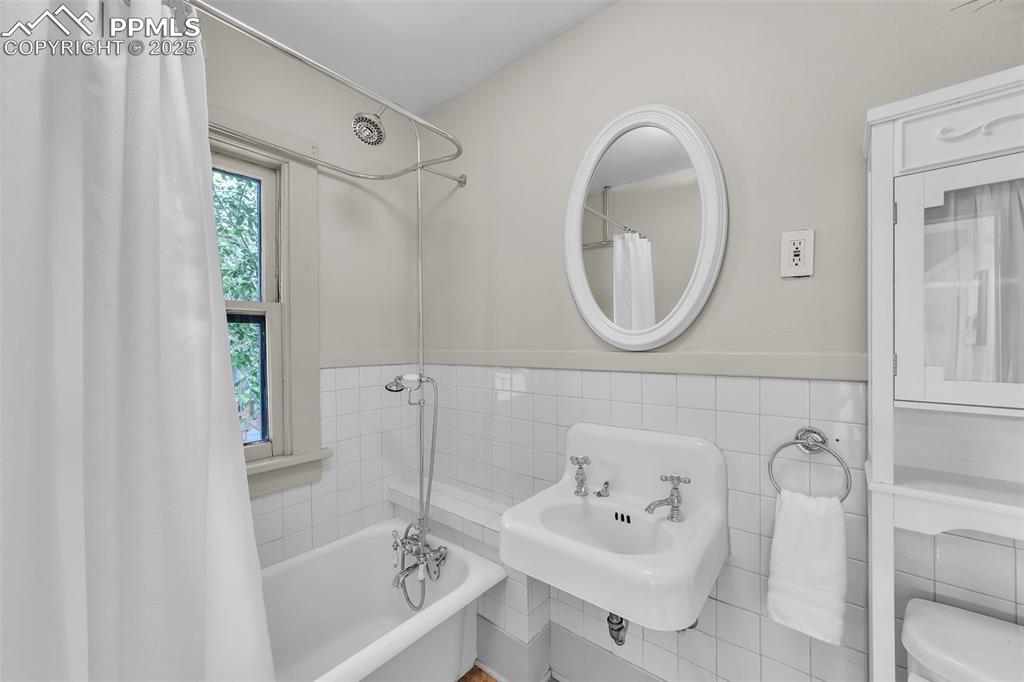 319 South Institute Street Colorado Springs, CO 80903 - Photo 19 of 49 a bathroom with a sink a toilet and a mirror