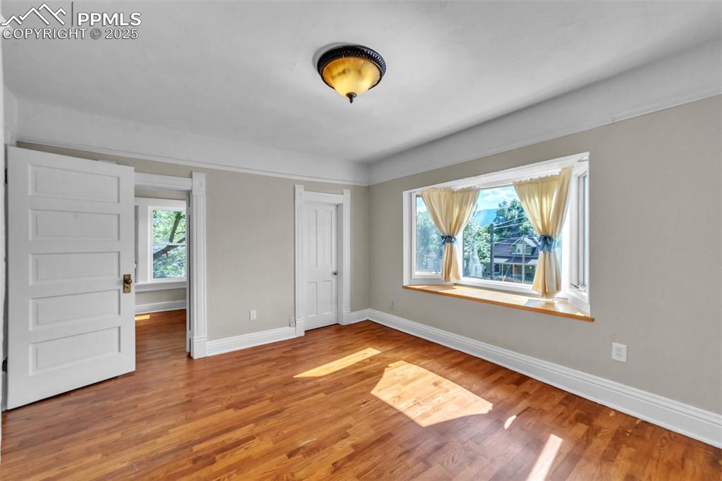 319 South Institute Street Colorado Springs, CO 80903 - Photo 21 of 49 a view of an empty room with wooden floor and a window