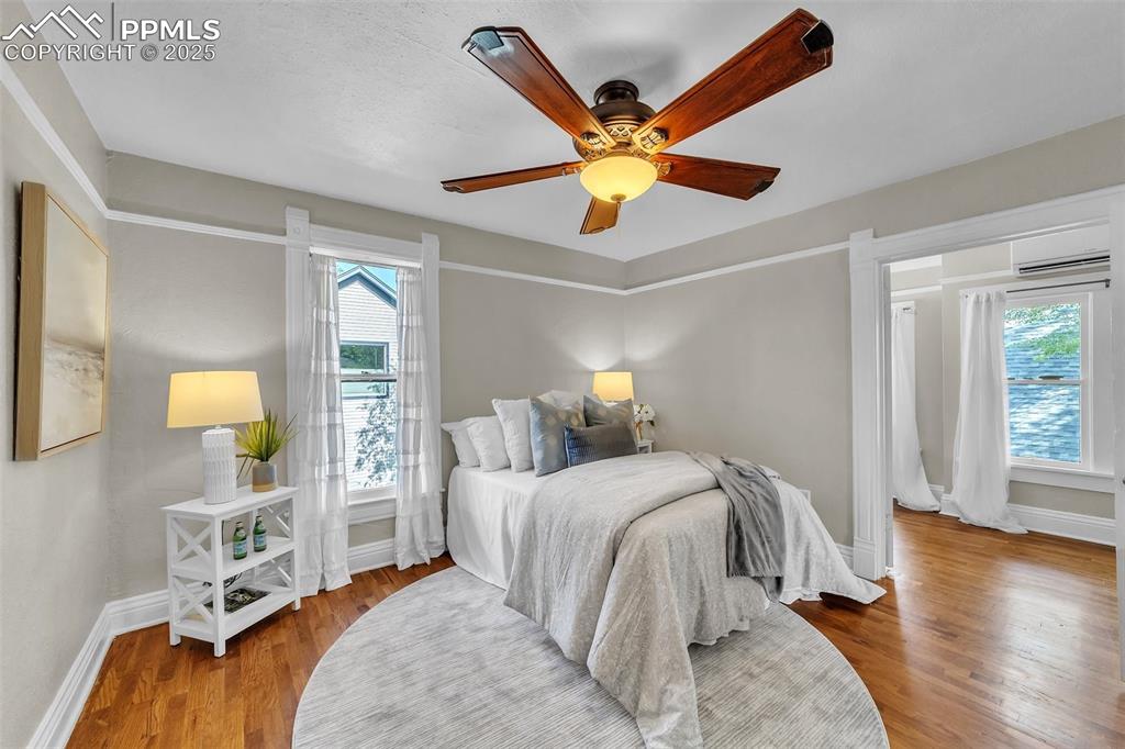 319 South Institute Street Colorado Springs, CO 80903 - Photo 24 of 49 a bedroom with a bed and a chandelier