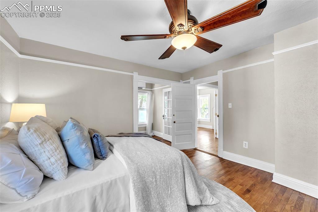 319 South Institute Street Colorado Springs, CO 80903 - Photo 25 of 49 a bedroom with a large bed and a chandelier