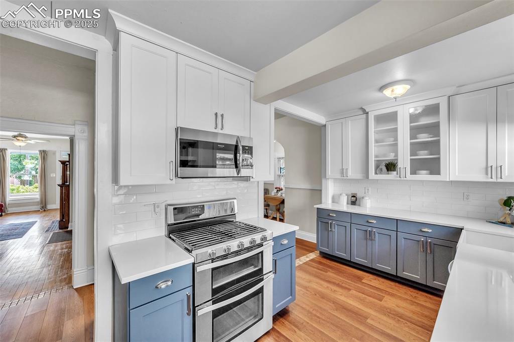 319 South Institute Street Colorado Springs, CO 80903 - Photo 10 of 49 a kitchen with stainless steel appliances a stove cabinets and wooden floor