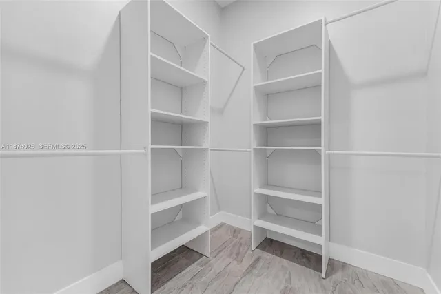 a bathroom with a toilet a sink a mirror and vanity