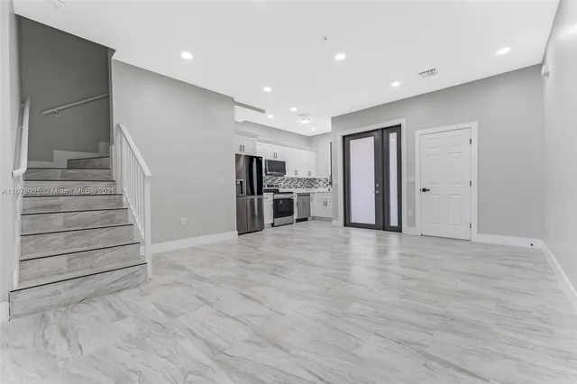 a kitchen with a refrigerator stove and microwave