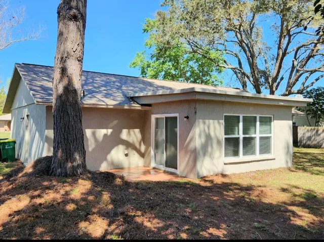 a front view of a house with a yard garage and chair