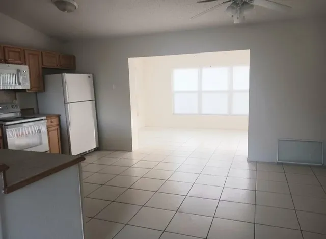 a view of a kitchen with a microwave and a sink