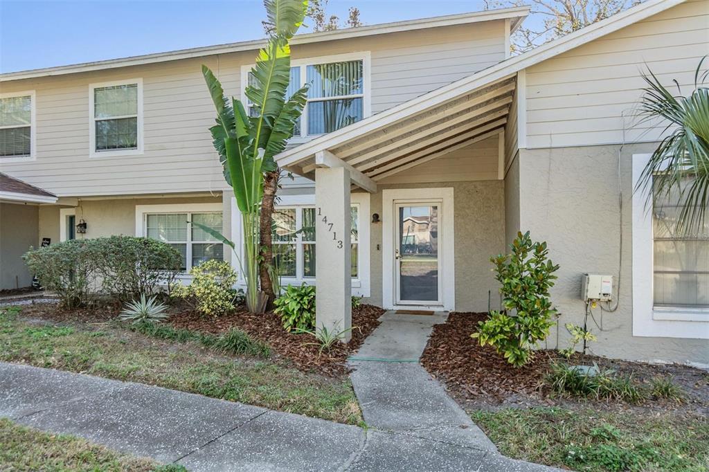 a front view of a house with garden