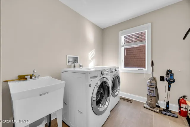 a bathroom with a double vanity sink a mirror and a toilet