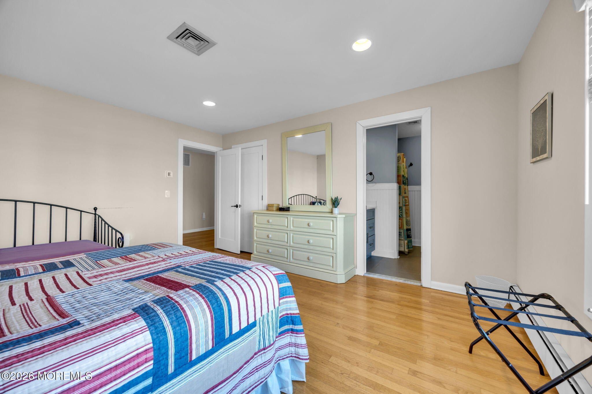211 Forman Avenue Point Pleasant Beach, NJ 08742 - Photo 25 of 69 a bedroom with a bed and a chandelier