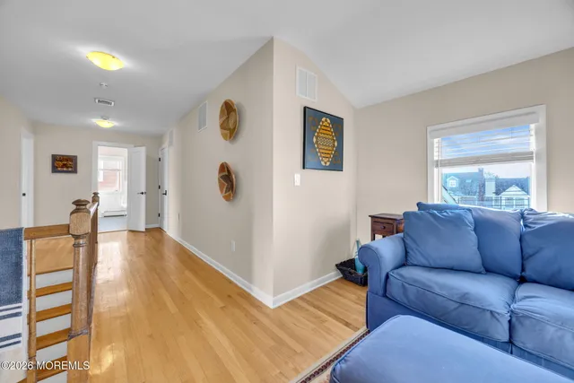a view of a roof deck with table and chairs a barbeque with wooden floor and fence