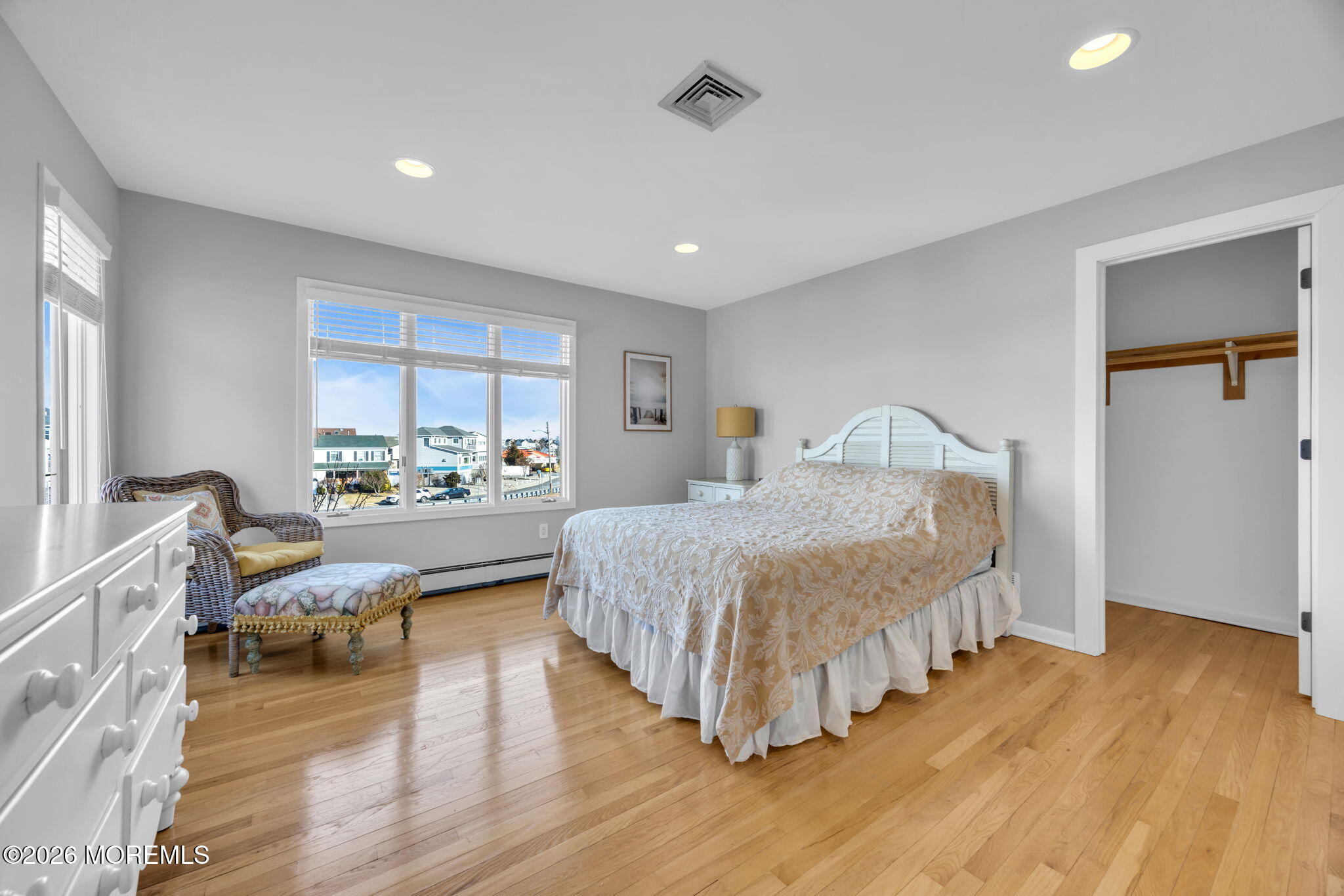 211 Forman Avenue Point Pleasant Beach, NJ 08742 - Photo 32 of 69 a spacious bedroom with a large bed and a wooden floor