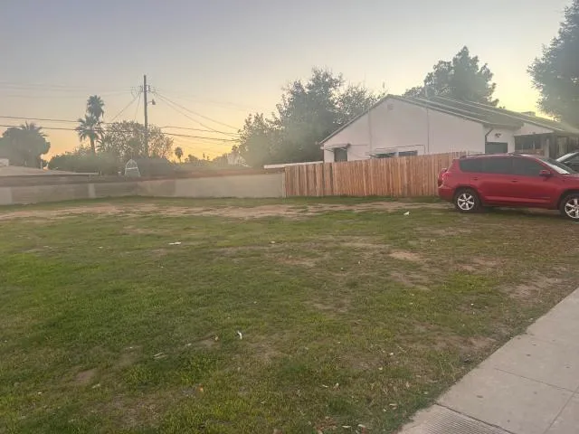 a backyard of a house with table and chairs