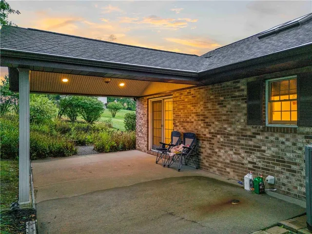 a backyard of a house with outdoor seating