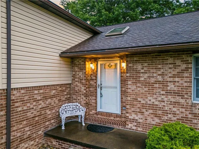 a front view of a house with outdoor seating