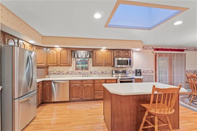 a kitchen with stainless steel appliances granite countertop a stove refrigerator sink and cabinets