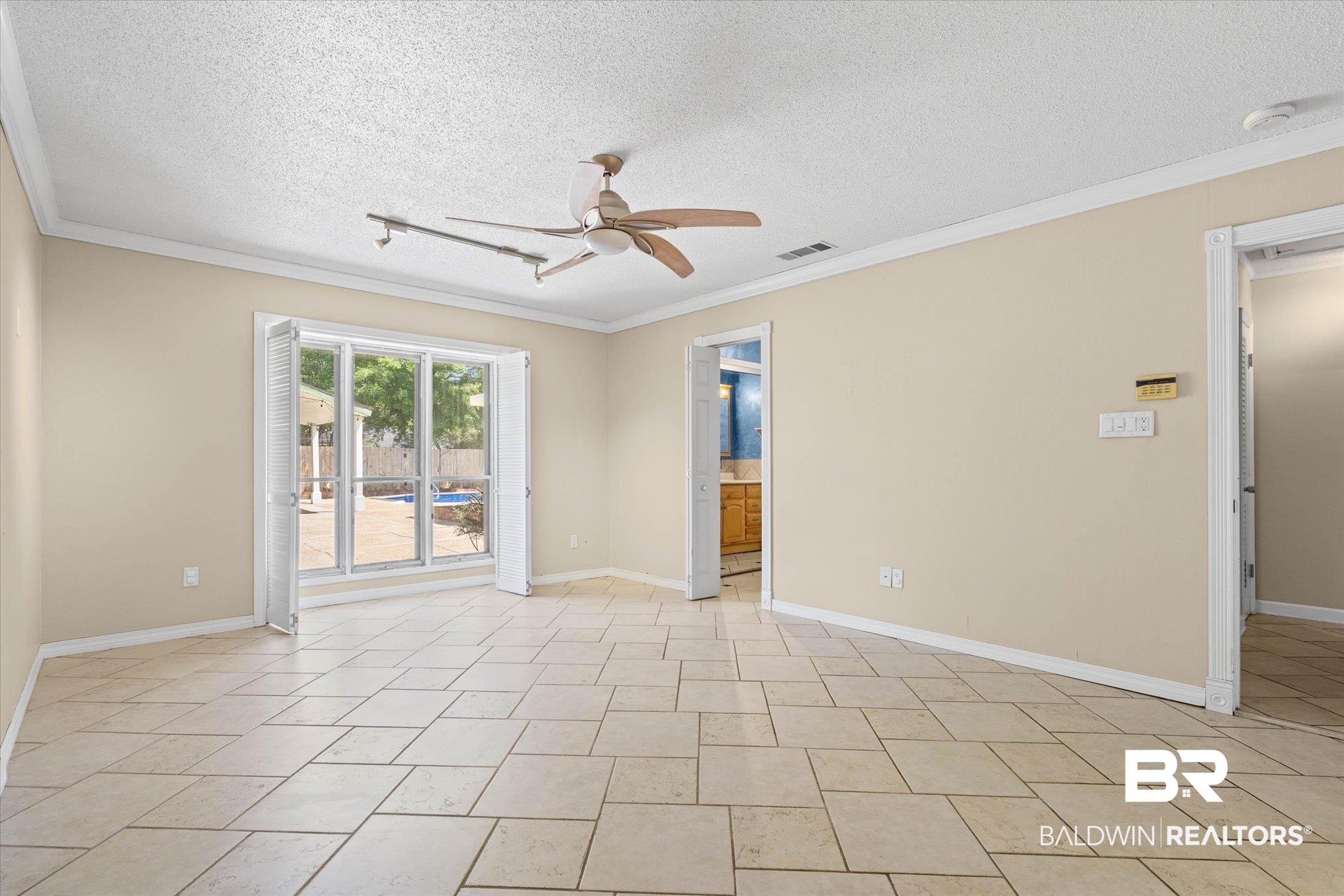 3724 Claridge Road South Mobile, AL 36608 - Photo 16 of 42 Unfurnished room featuring a ceiling fan, a textured ceiling, and ornamental molding