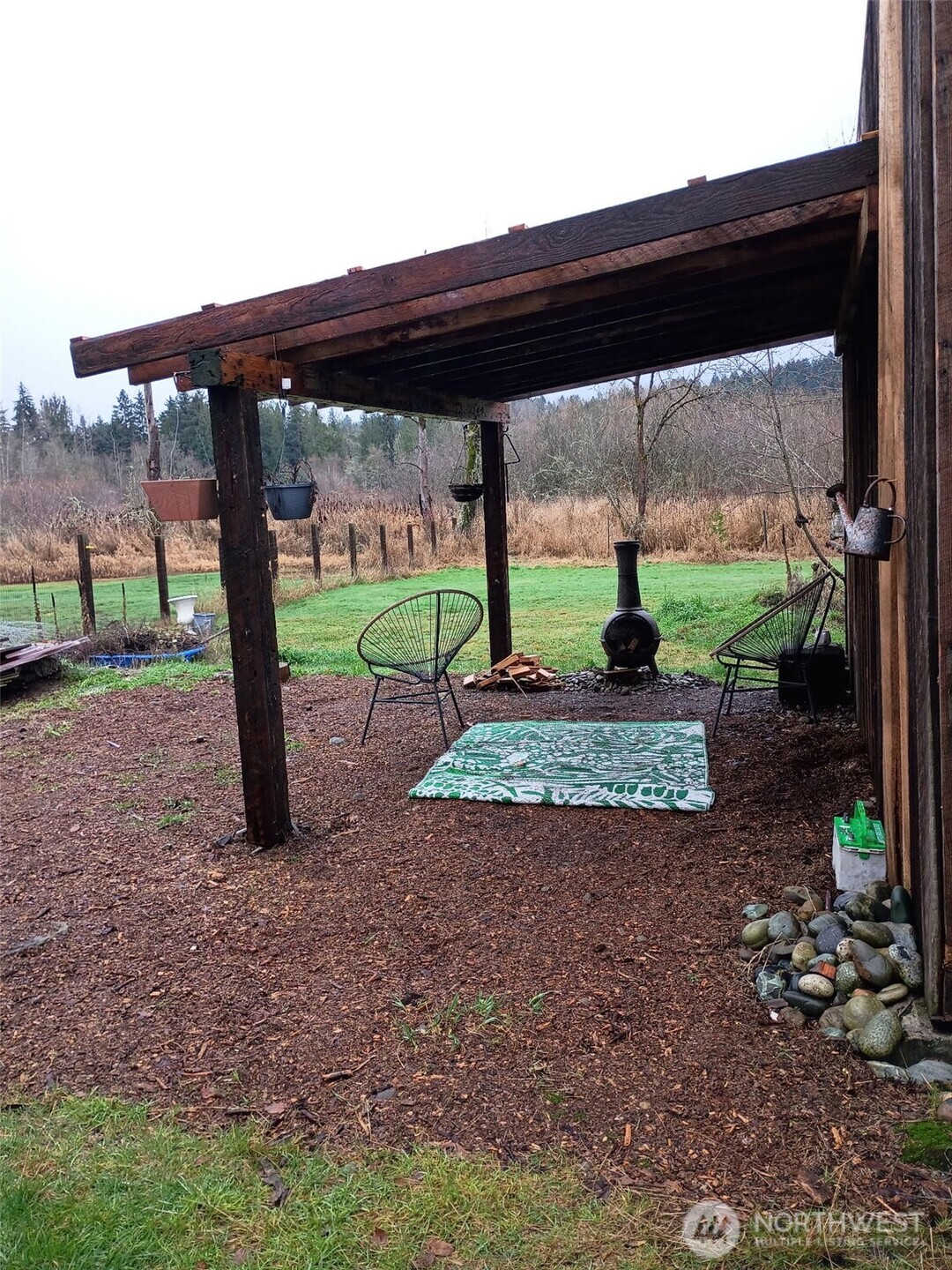 25115 72nd Avenue East Graham, WA 98338 - Photo 8 of 10 a view of a porch with a table chairs and a backyard
