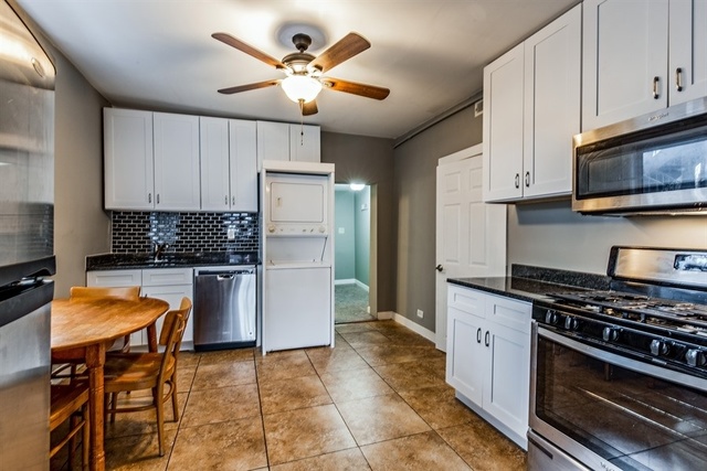 1114 West Cullerton Street, Unit 1 Chicago, IL 60608 - Photo 2 of 10 a kitchen with stainless steel appliances granite countertop a stove refrigerator sink and microwave