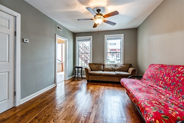 1114 West Cullerton Street, Unit 1 Chicago, IL 60608 - Photo 3 of 10 a living room with furniture and a wooden floor