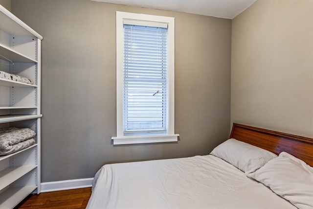 1114 West Cullerton Street, Unit 1 Chicago, IL 60608 - Photo 8 of 10 a bedroom with a bed and a window