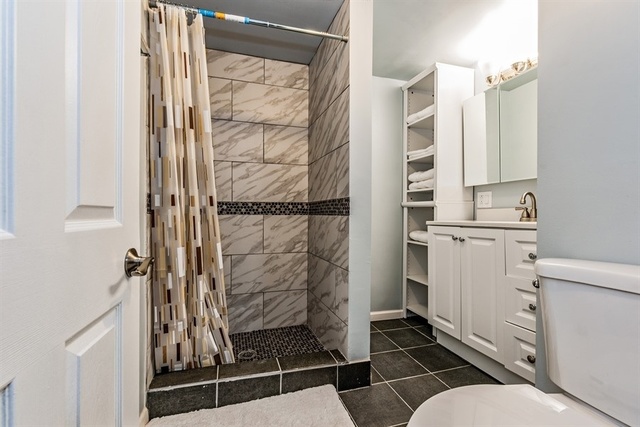 1114 West Cullerton Street, Unit 1 Chicago, IL 60608 - Photo 9 of 10 a bathroom with a sink toilet and shower