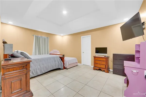 a bedroom with a bed and flat screen tv