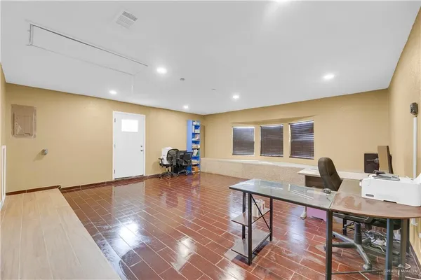 a workspace with furniture window and wooden floor